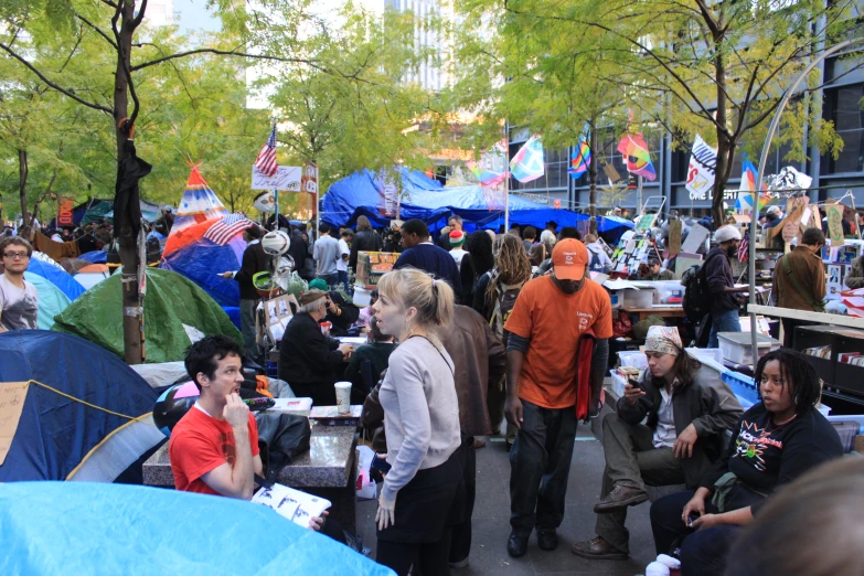 a large group of people with tents near trees