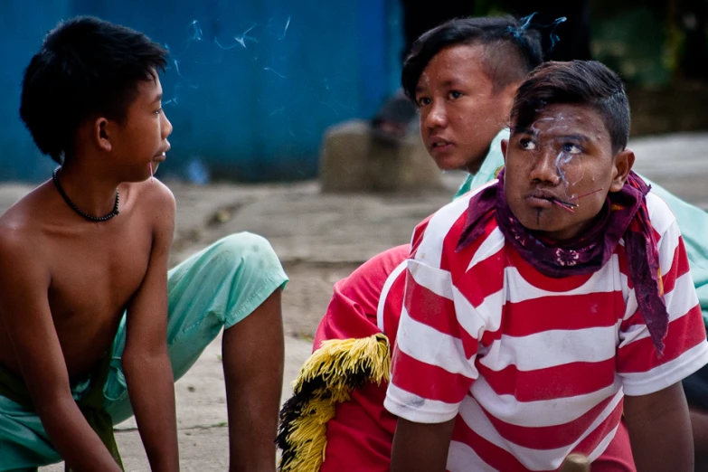 three children sitting around with some food