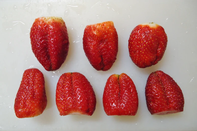 a close up of nine sliced strawberries