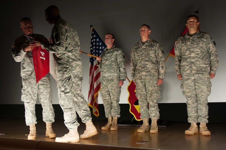 some guys with flags in their hands are posing