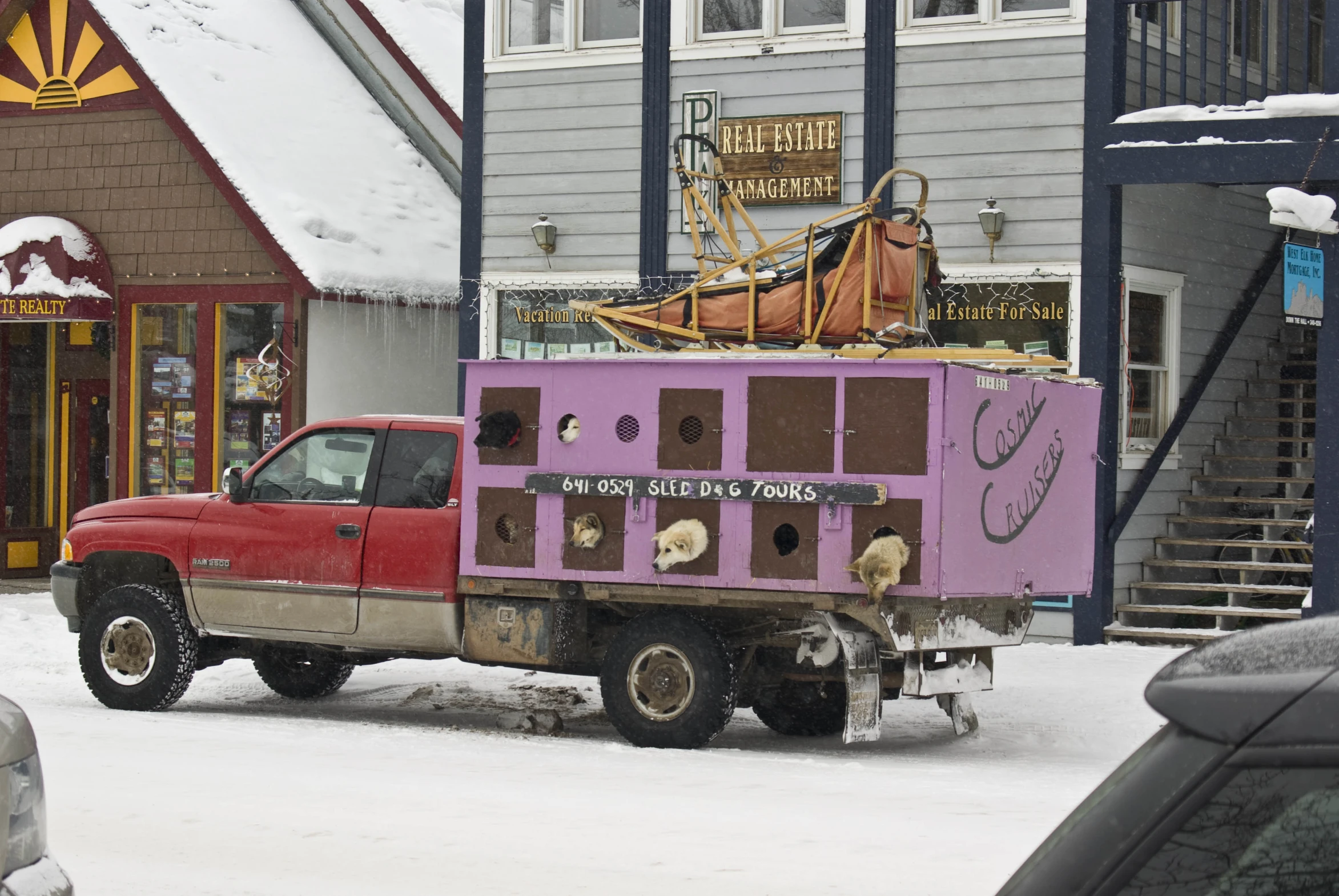 the red pick up truck has been pulled over and covered in snow