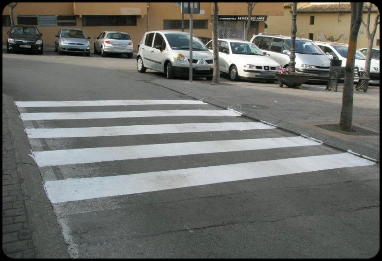 several cars parked at an intersection on the street