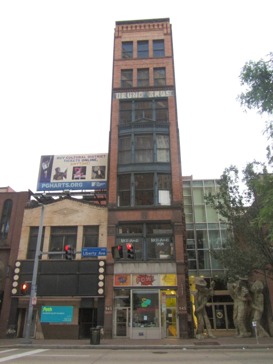 an intersection in front of a brick and glass building