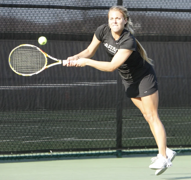 a lady that has a racket in her hand