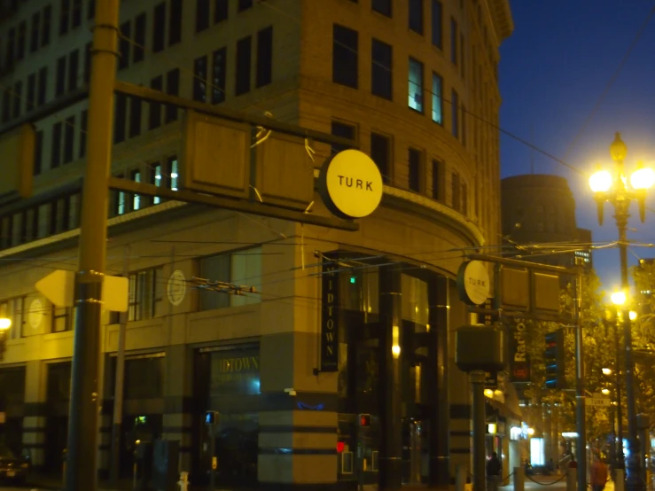 a tall building with a clock on top near lights