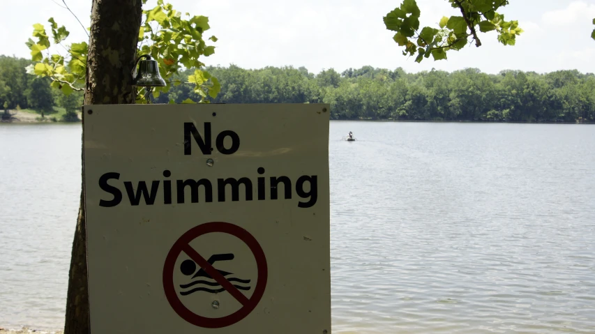 the sign says no swimming is here,