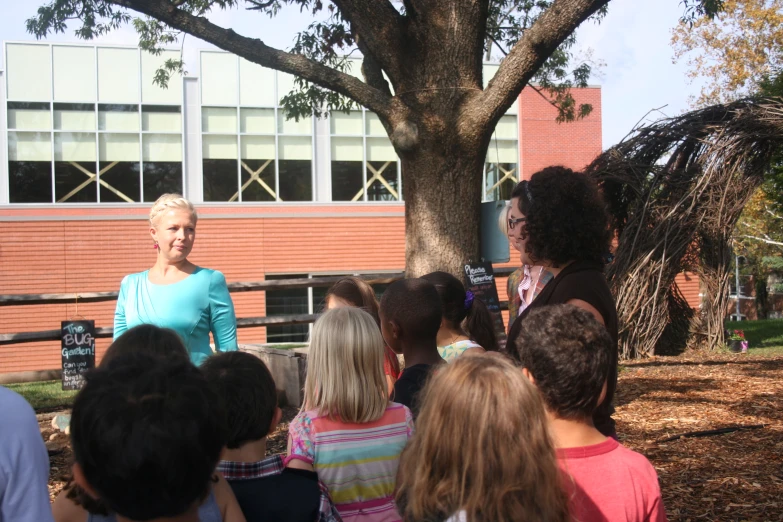 an older woman standing next to some children