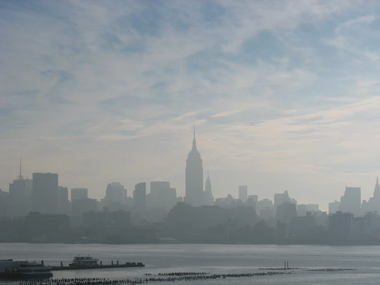 a large city skyline covered in fog and water