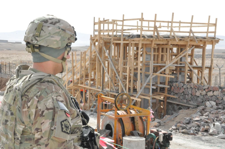 a soldier standing in front of a construction site