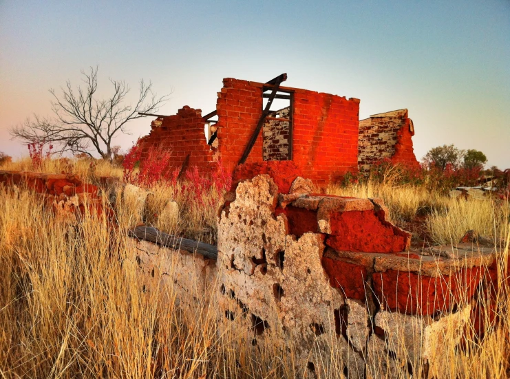 this ruined building is being demolished in the grass