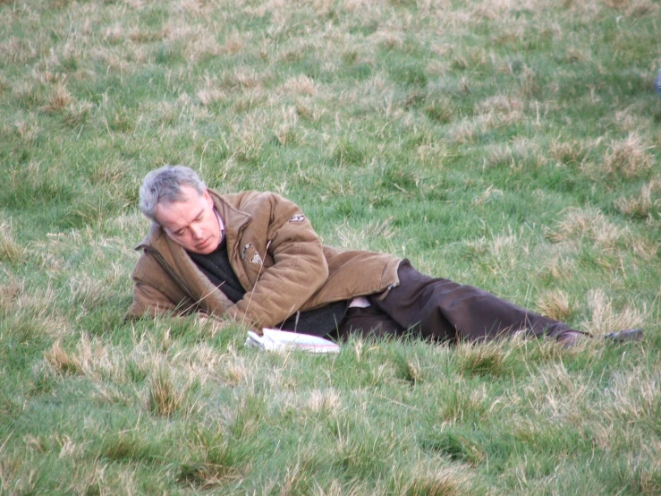 an older man in the grass with a frisbee