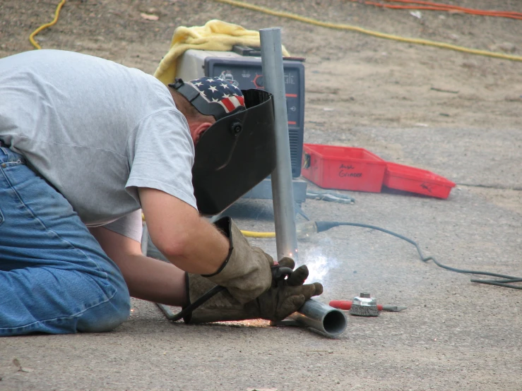 a worker working on a street sign near a machine