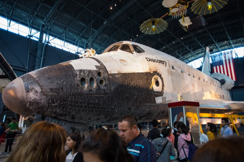 a space shuttle hanging in a crowd of people