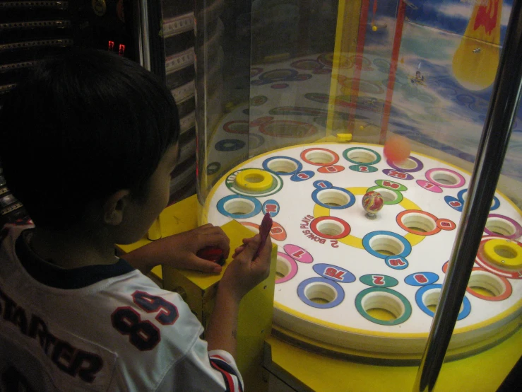 a little boy is in front of a large board game