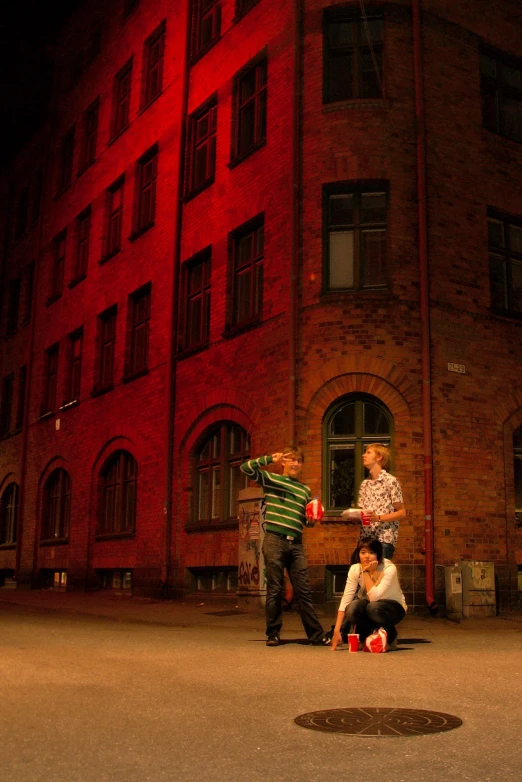 a  and girl dancing in front of an apartment building