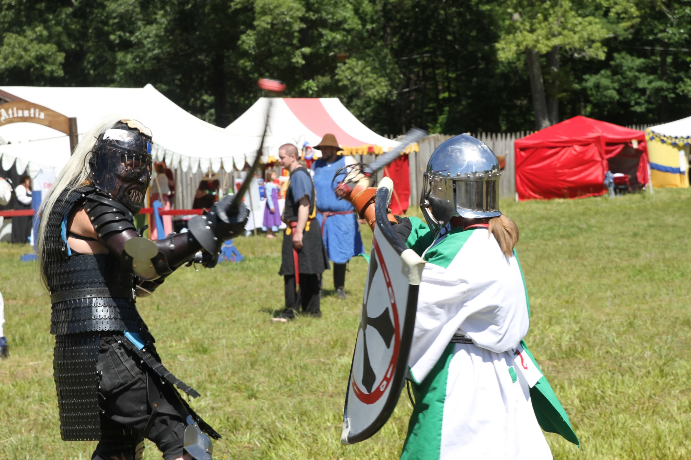 some people in costume are playing with swords