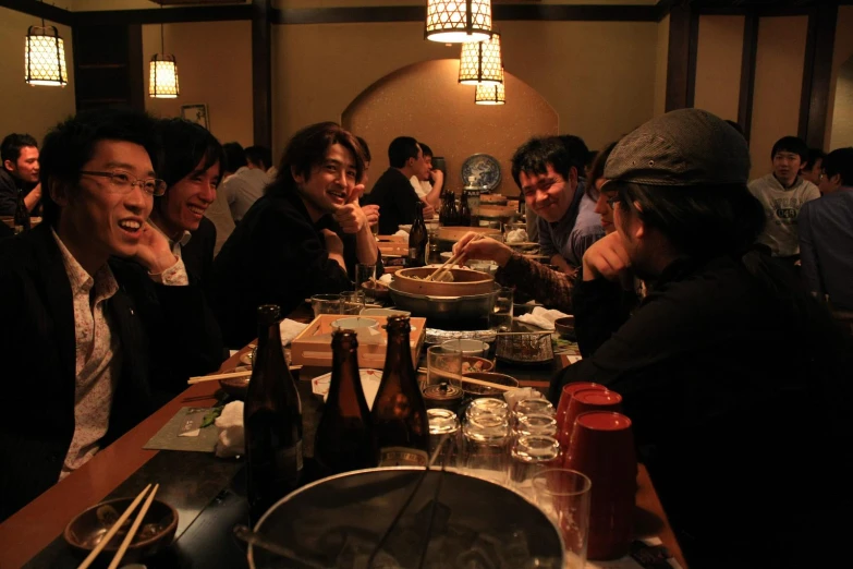 a large group of asian people sitting at a table