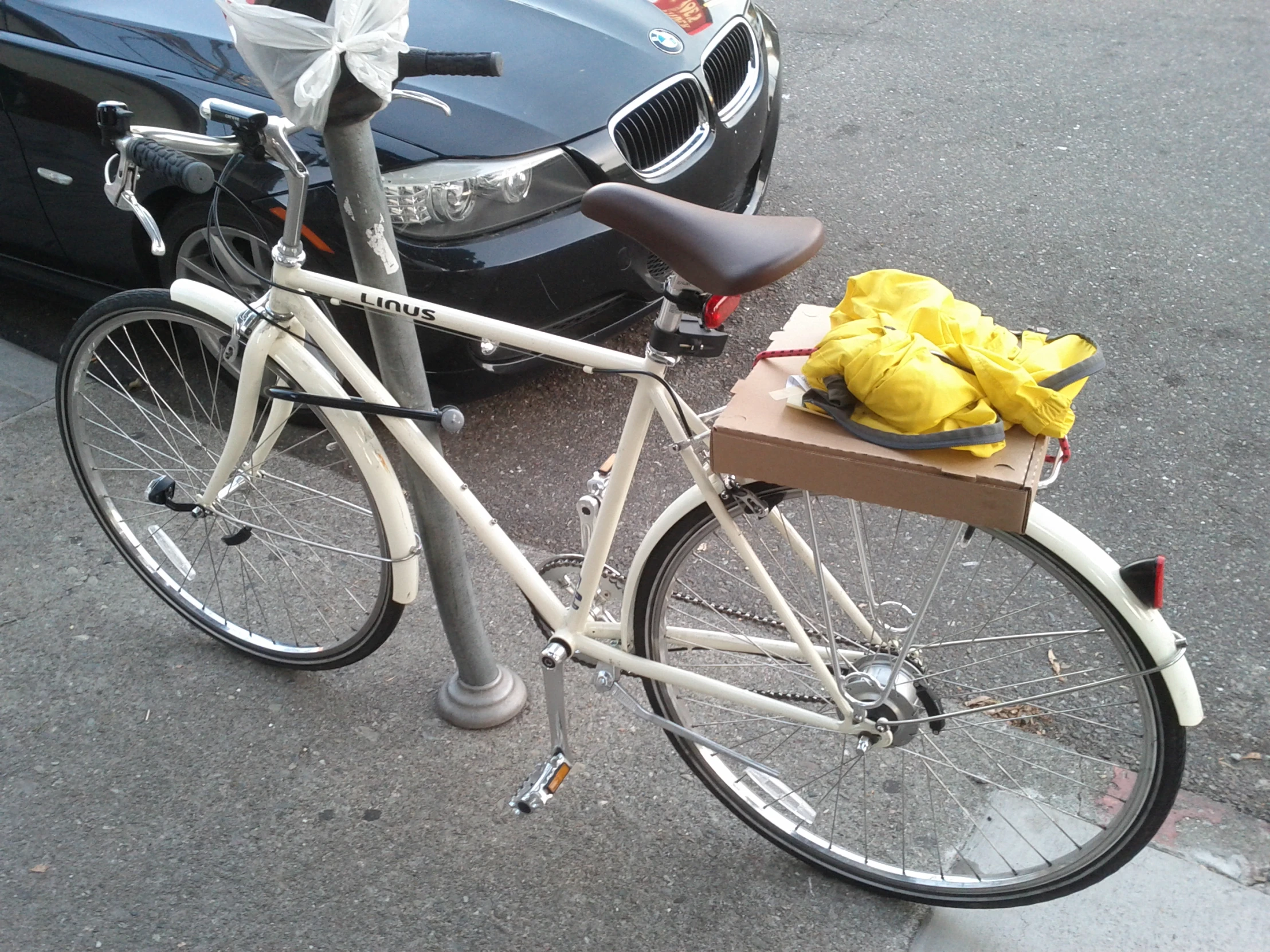 a bike with a box full of yellow gloves parked next to it
