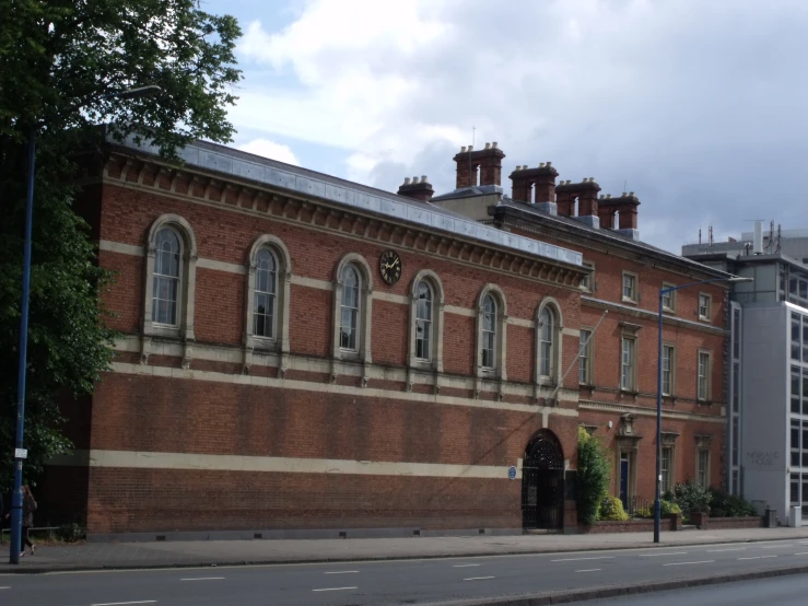 an old brick building is in front of a modern office