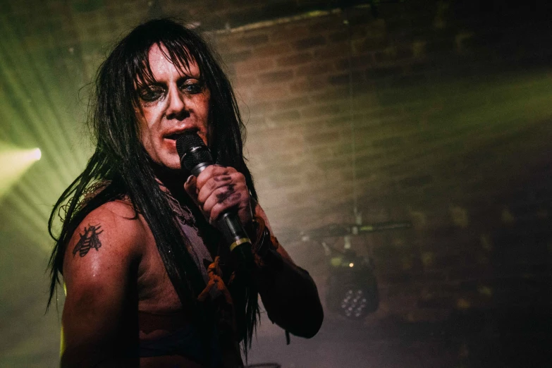 a male concert stage performer on stage in front of a crowd