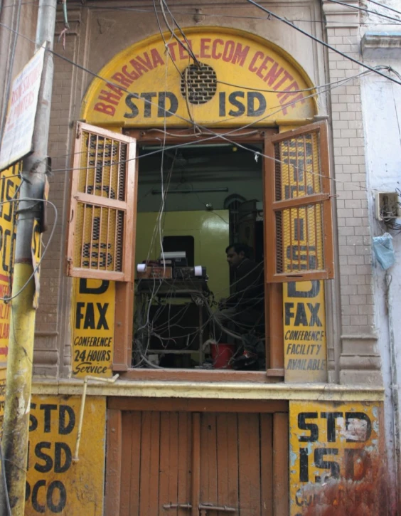 a man is working on his computer in a doorway