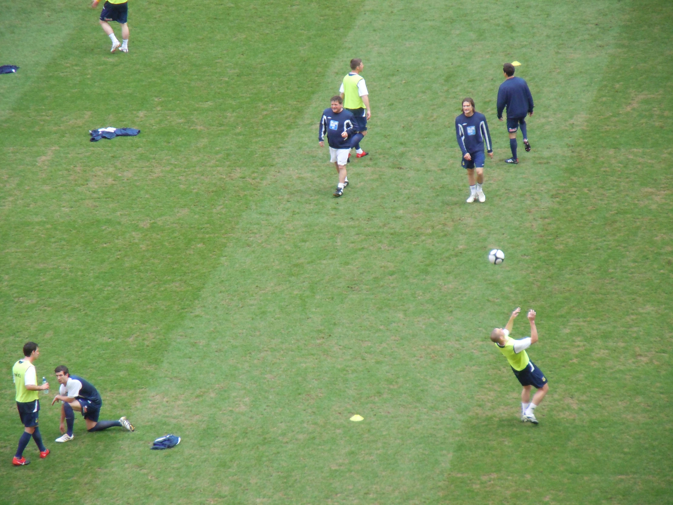 soccer players are playing ball in an open field