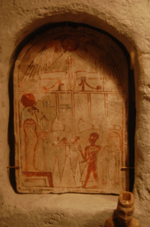ancient egyptian painted paintings on wall with a lamp in foreground