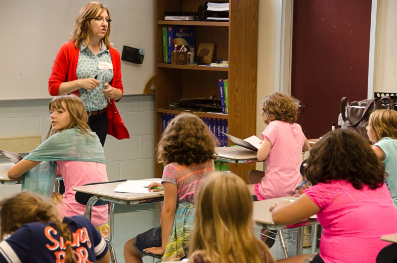 a teacher is teaching in her class at school