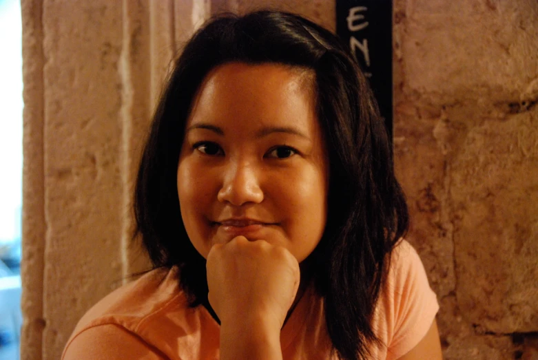 a woman sitting and smiling at the camera