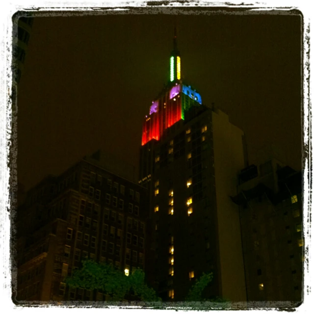 a view of a large building lit with colored lights