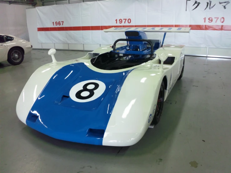 a racing car with a number on it in a garage