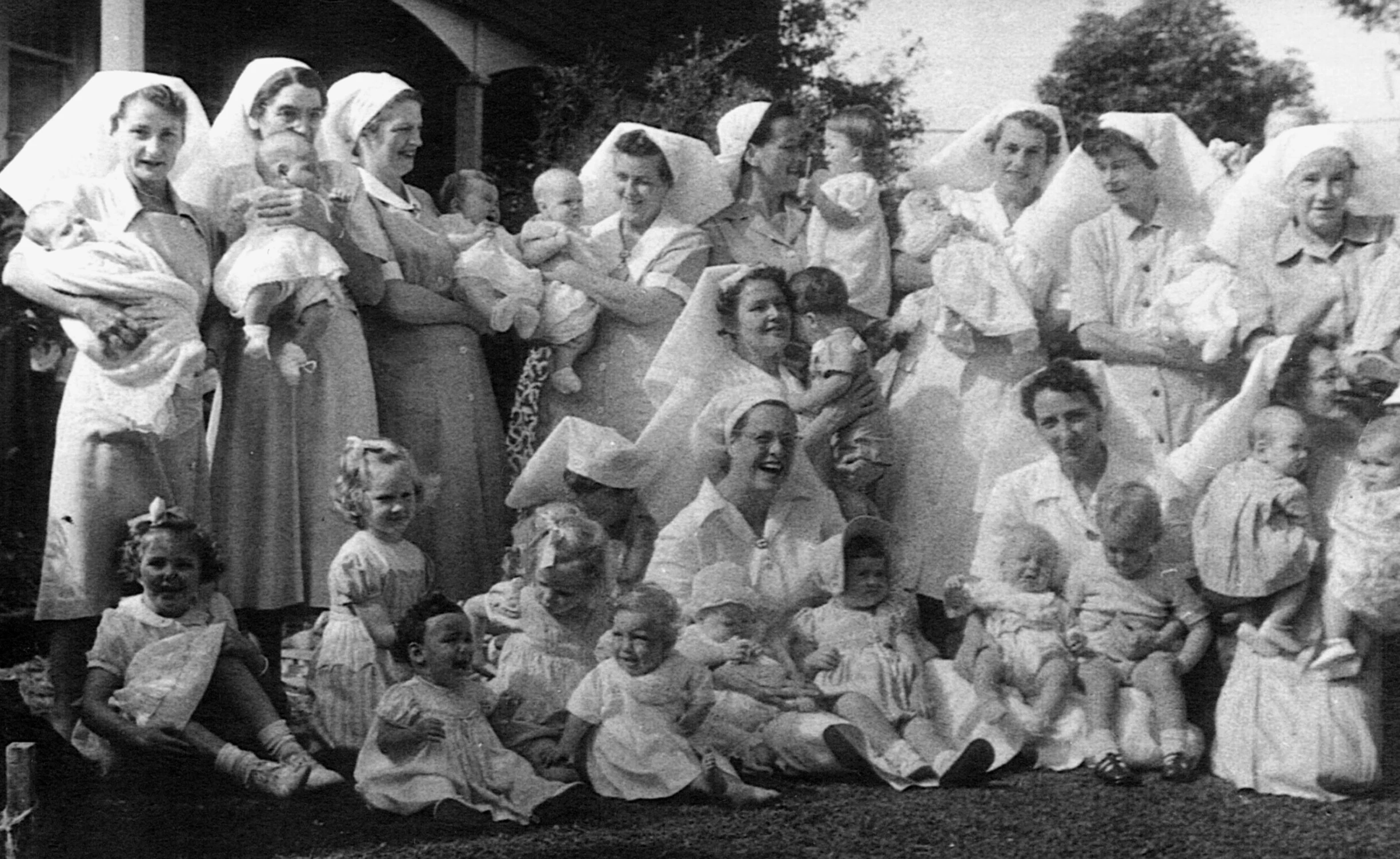 an old picture of a group of people in dresses