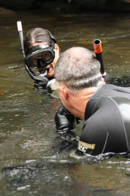 the man is using an oxygen tube to watercraft