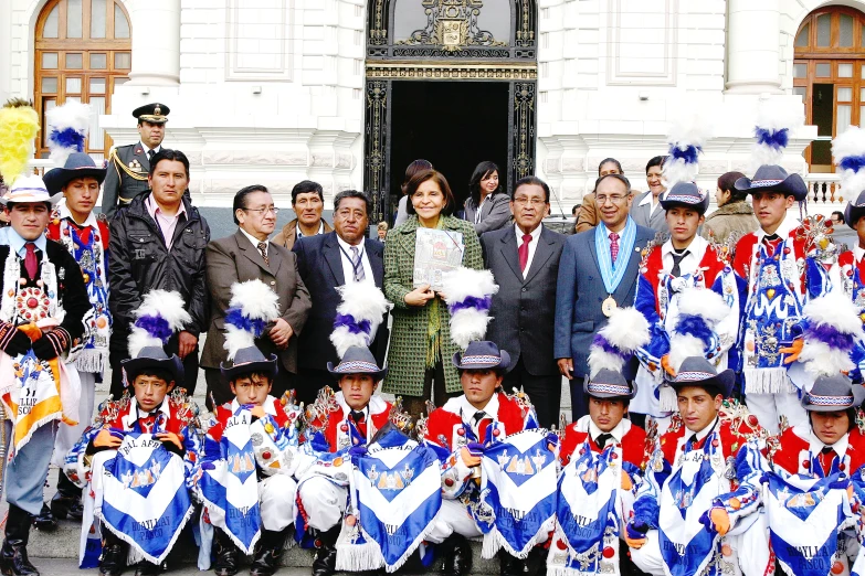 a group of men and women are posing for the camera while people hold their hats