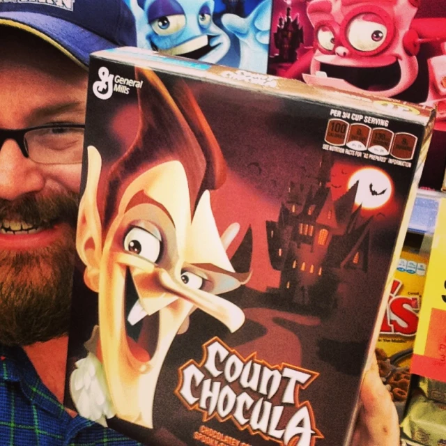 a man is holding a box of count chocolate