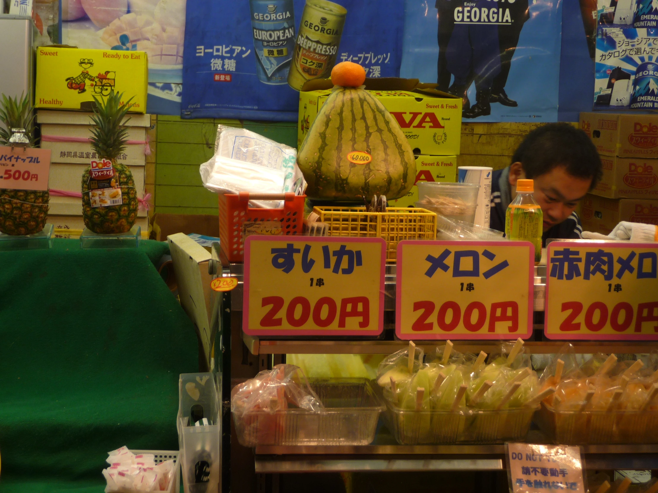 a stand with fruit and decorations in an asian market