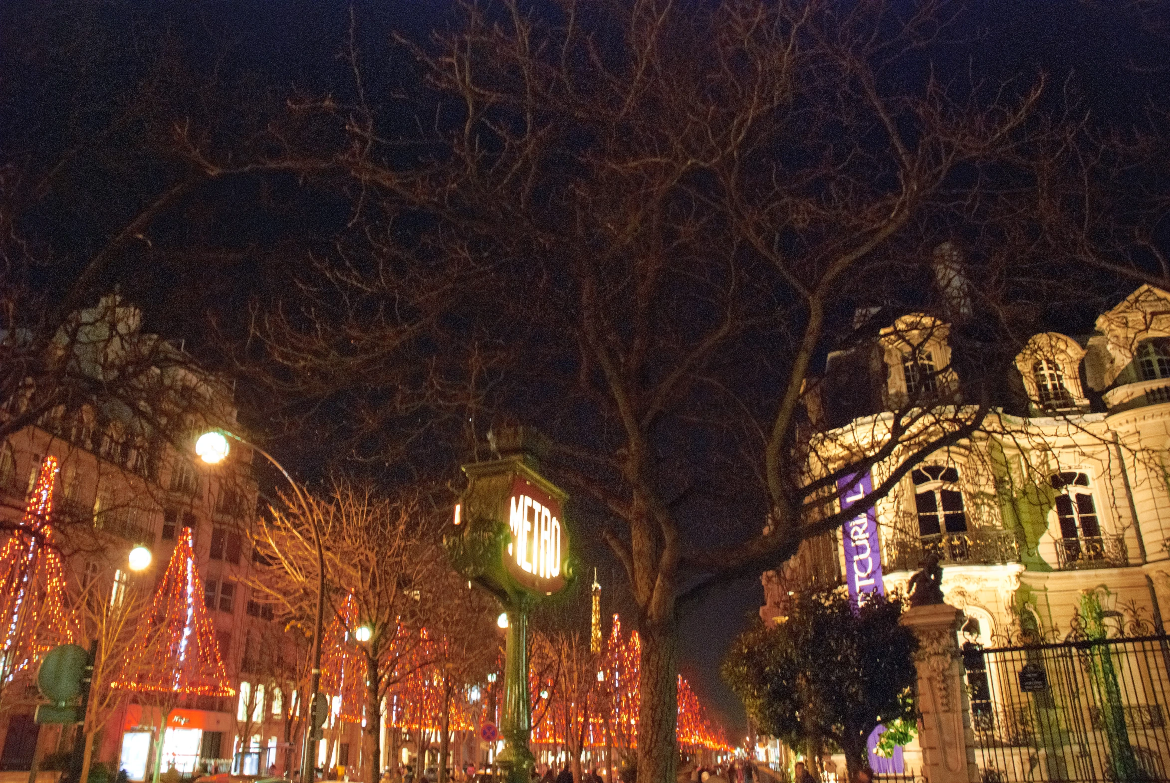 people walk through the cobblestone streets at night