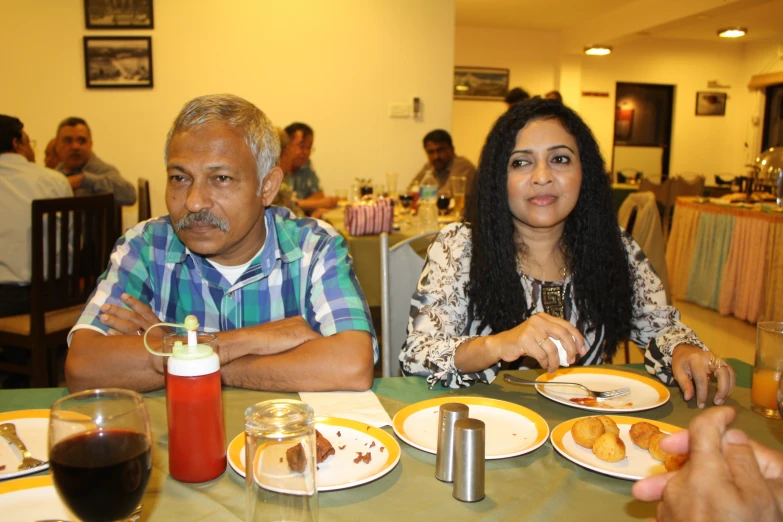 a couple of people that are sitting in front of some plates