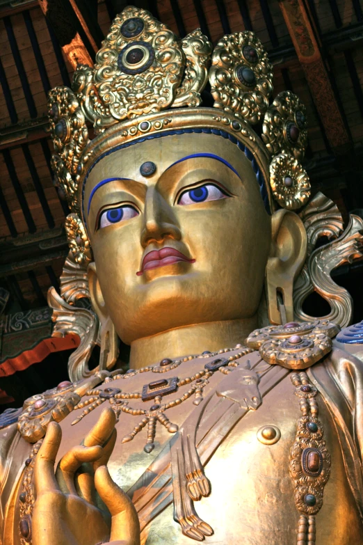 an elaborate golden statue with blue eyes