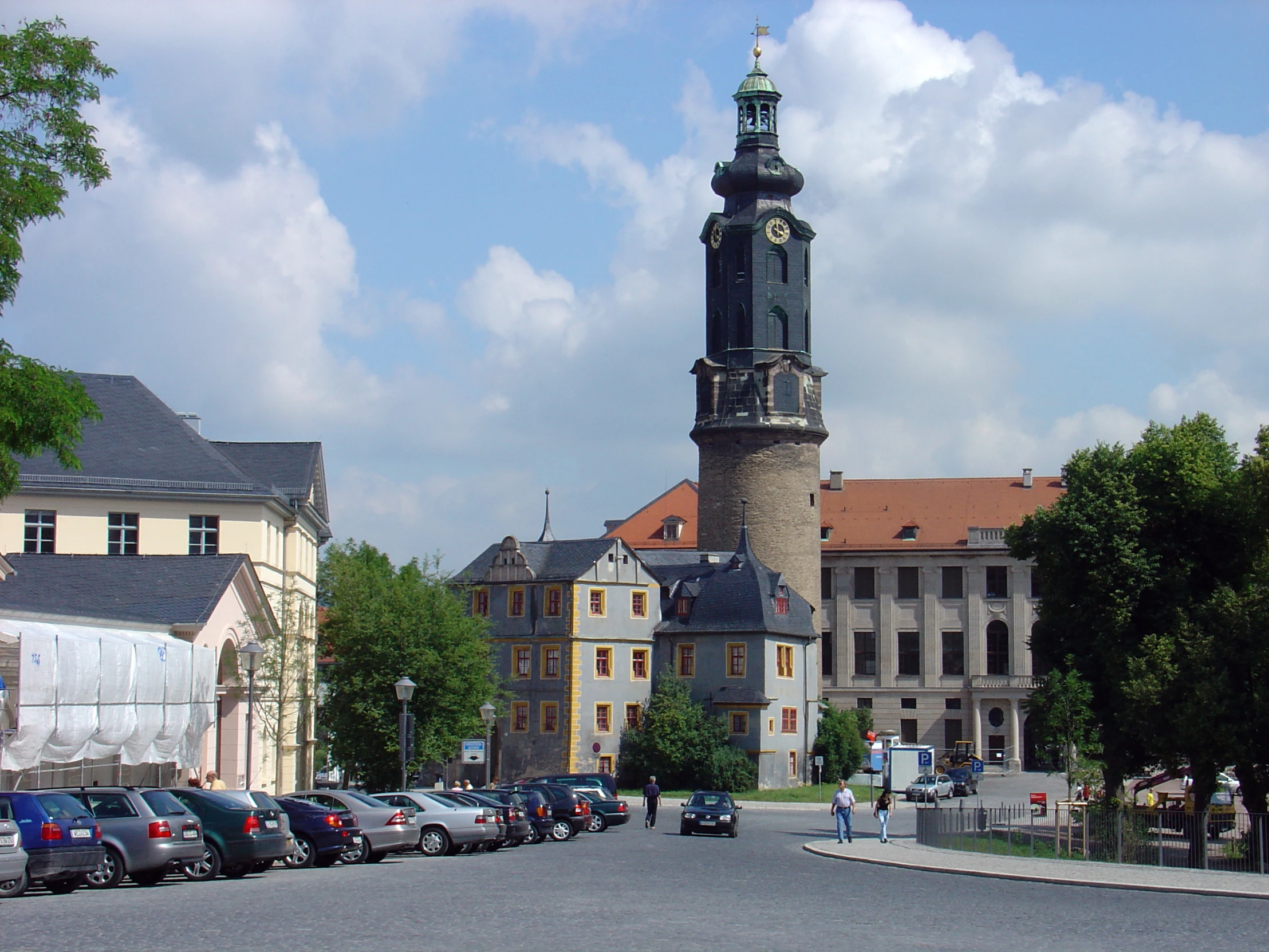 an old church and a street in the center of a town