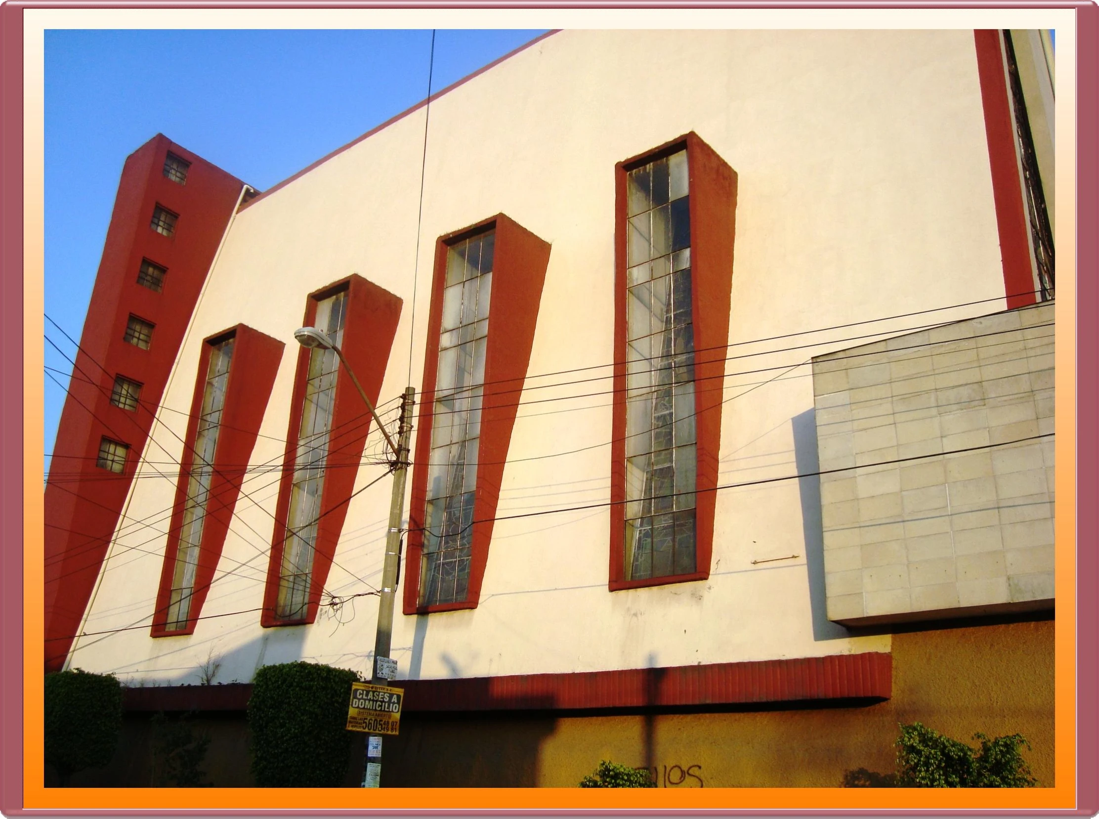 two tall red windows on the side of a building