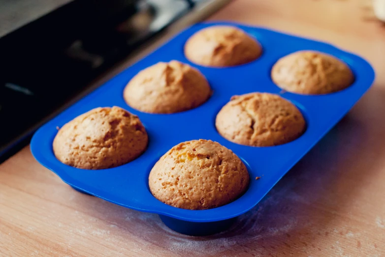 a blue tray with muffins in it