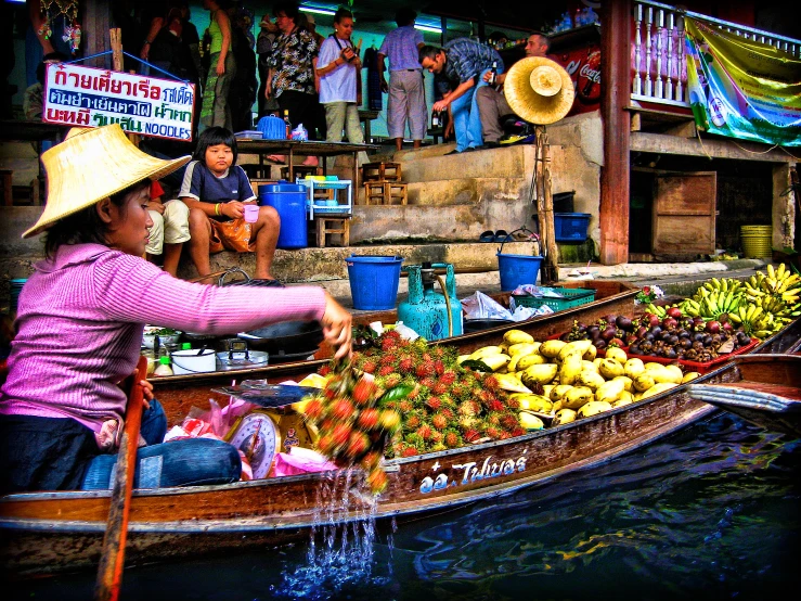 a man that is in a boat with some fruit