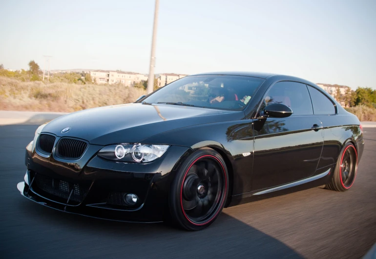 a black bmw parked in front of a large building