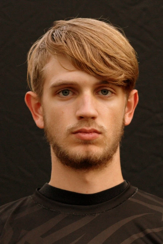 a man with a hair and beard is looking to the camera