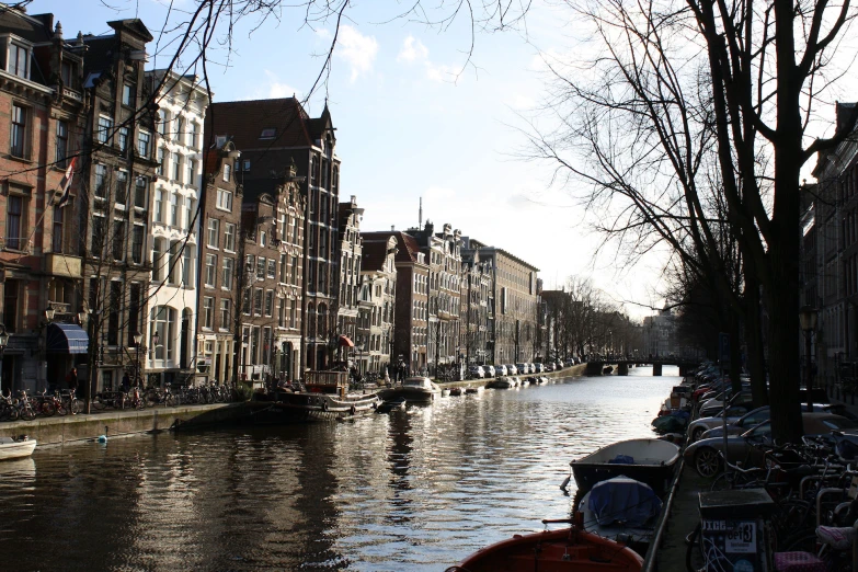 a boat moving down a street with other buildings and trees