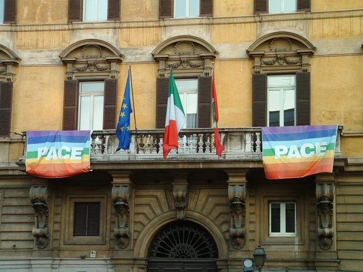 several flags are lined up outside of a building