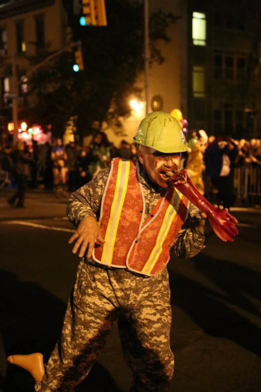 a man in camouflage is walking across the street