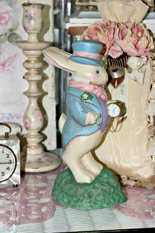 a stuffed rabbit toy and a clock are on a table