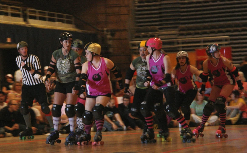 there is a group of roller skating people wearing helmets